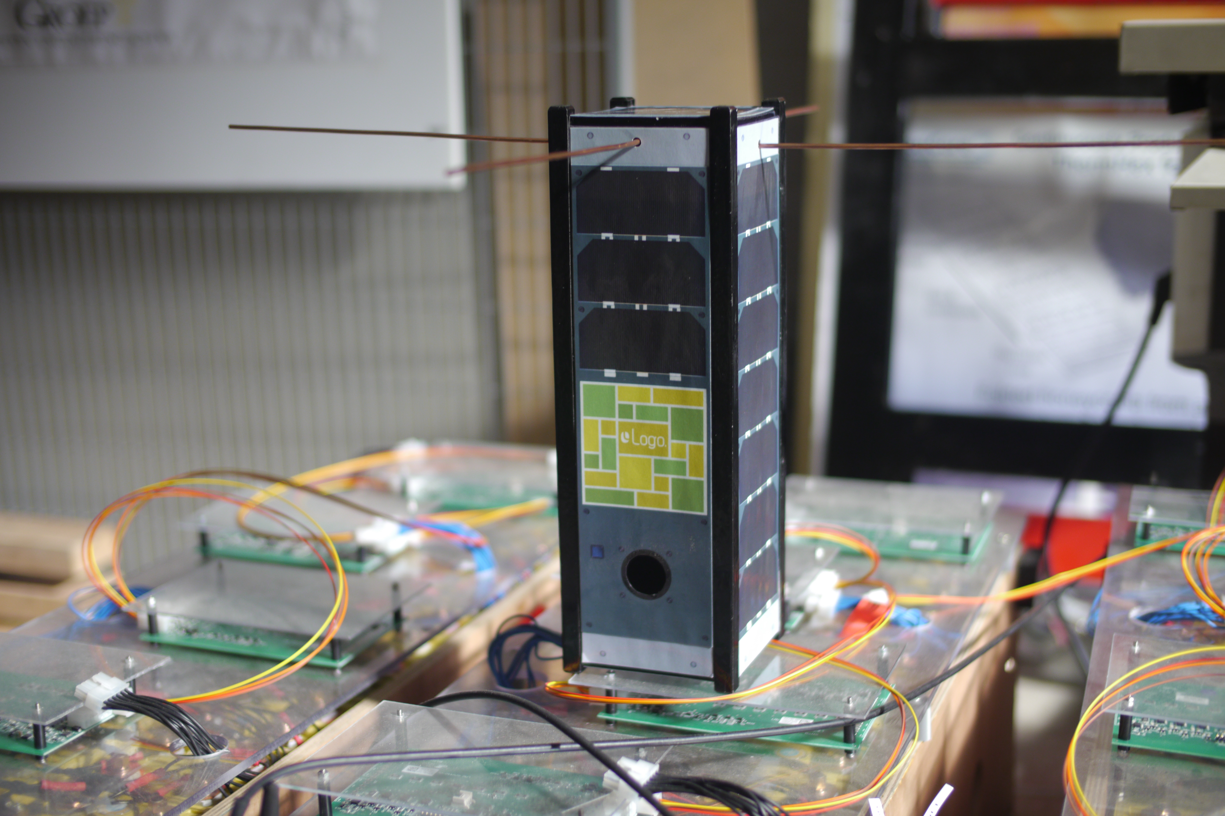 A mock-up of a CubeSat carrying an impression of the billboard, in an engineering lab.